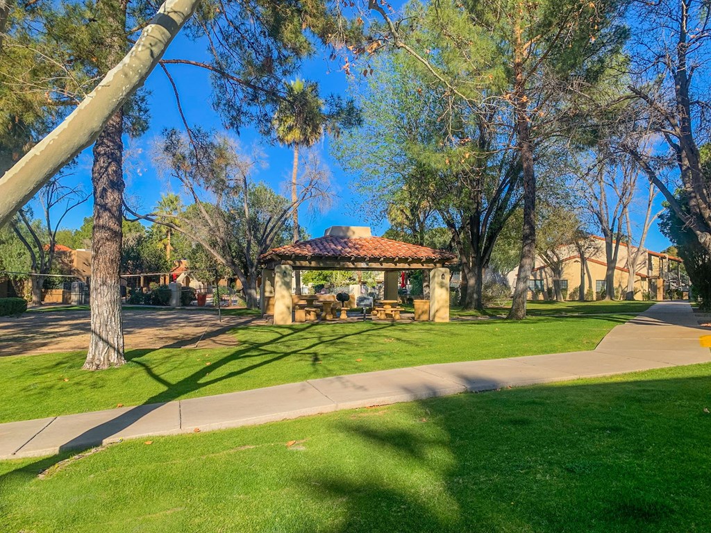 Community filled with mature trees and lush landscaping at La Hacienda Apartment, Tucson