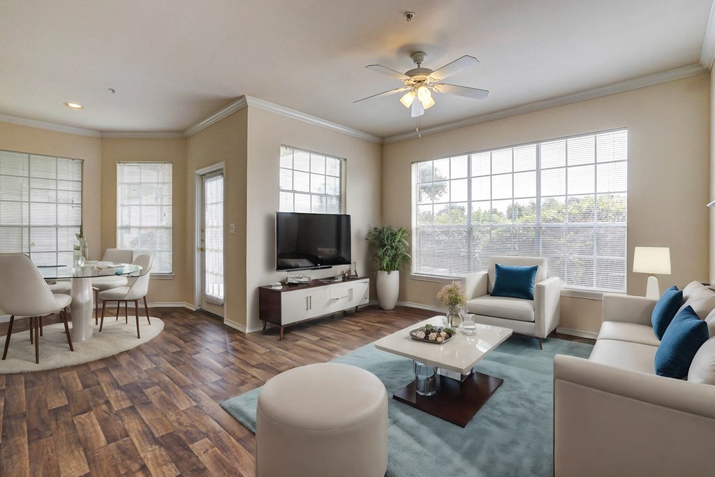 Light and bright living rooms with ample windows and hardwood floors at Turnberry Isle Apartment Homes, Texas, 75248