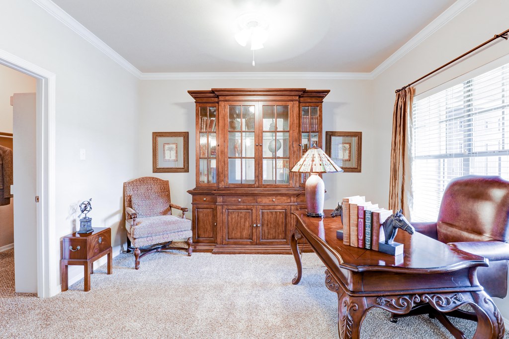 Wooden cabinet and desk with chair at SaddleBrook Apartments, Dallas, TX