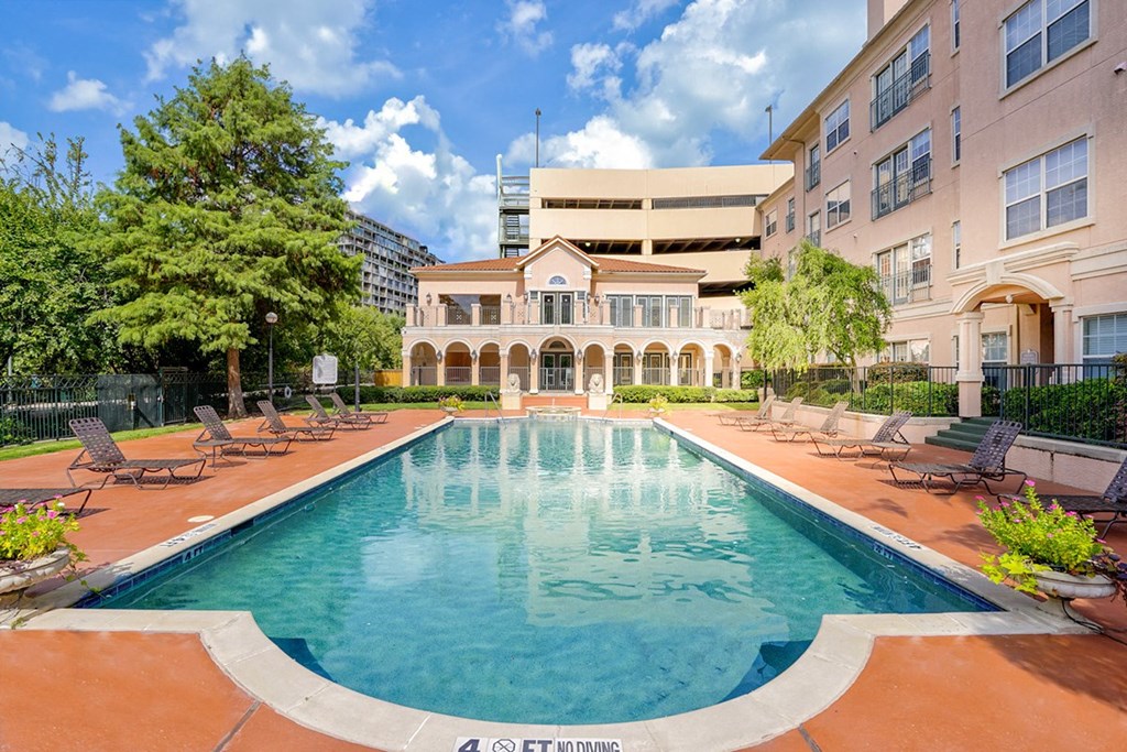 Resort-style swimming pool on a sunny day at Villas at Katy Trail Apartments, Texas