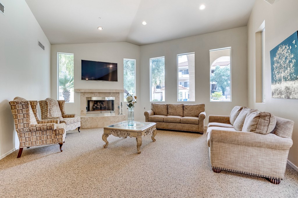 A living room with a fireplace and a television. at Ventana, Scottsdale, AZ