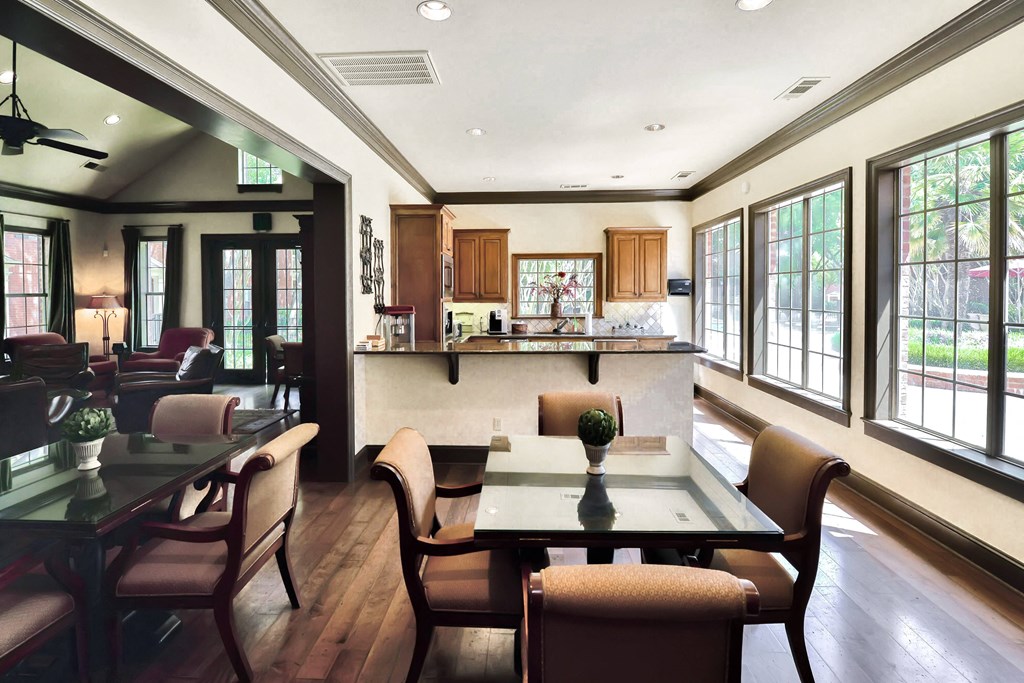 Interior of community clubhouse with large windows at SaddleBrook Apartments, Texas, 75248