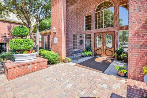 Exterior view of brick leasing office at Gates de Provence Apartments, Texas