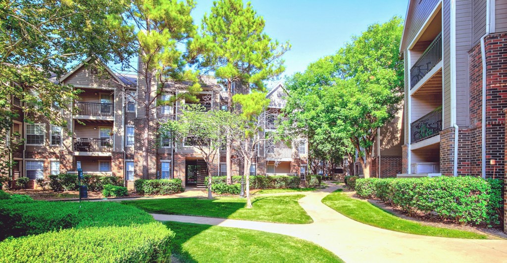 Mature trees and lush landscaping at Riverside Park Apartments, Tulsa