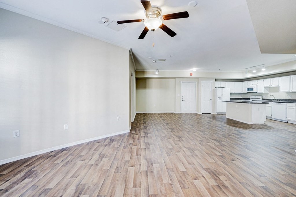 Interior living room with expansive layout and white walls at Villas at Katy Trail Apartments, Dallas