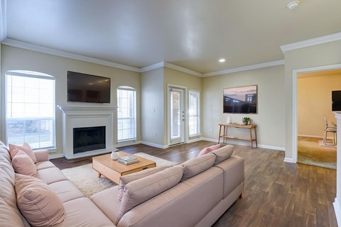 A living room with a couch, coffee table, and television.