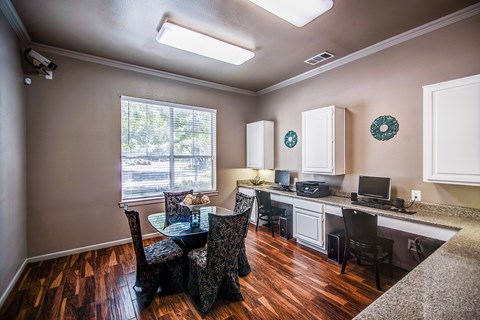 A dining room with a table and chairs.