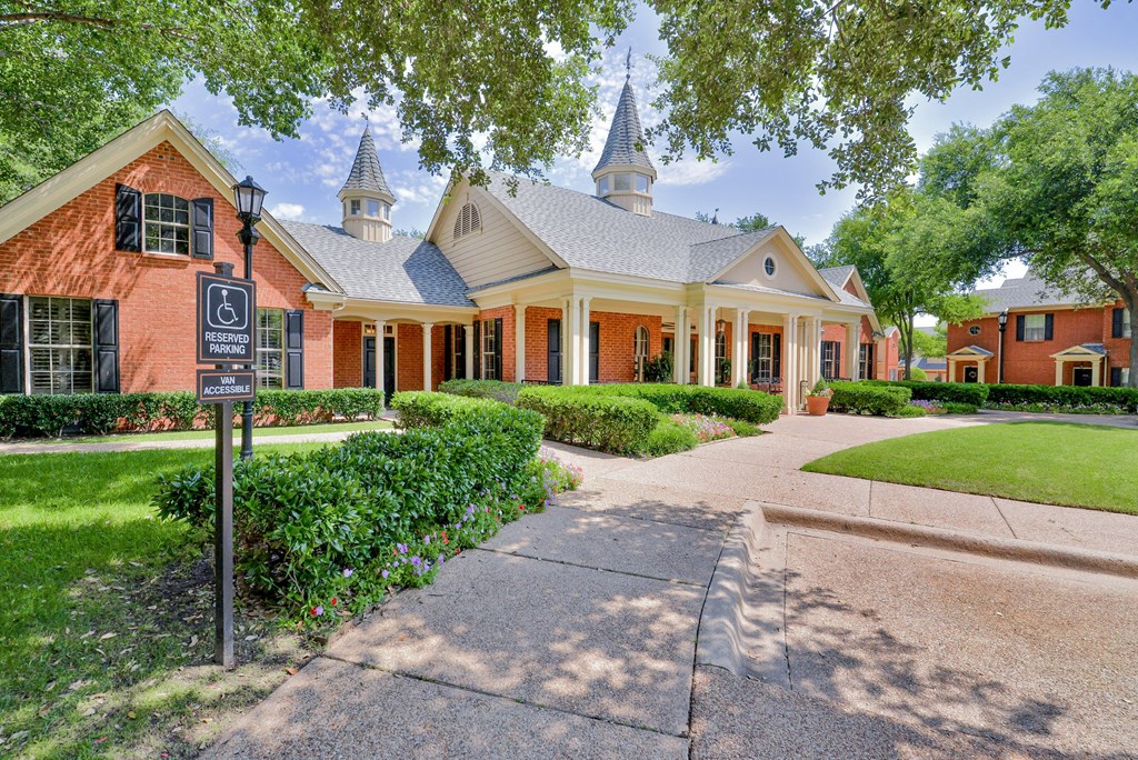 Exterior view of leasing office with green lawn at SaddleBrook Apartments, Dallas, TX, 75248
