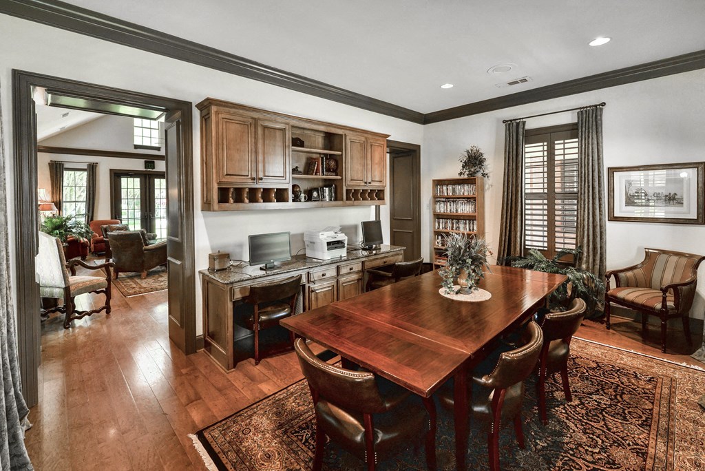 Dining room table with chairs and a carpet at SaddleBrook Apartments, Dallas