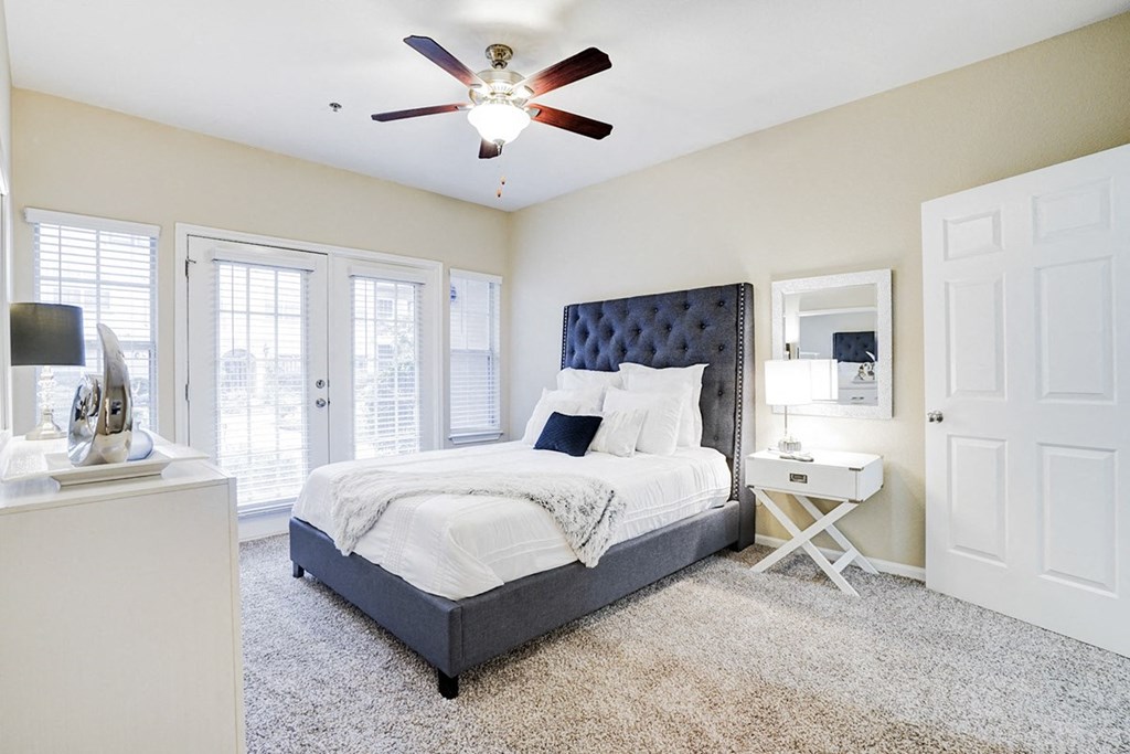 Large bedroom with ceiling fan and ample natural light at Villas at Katy Trail Apartments, Dallas, 75201