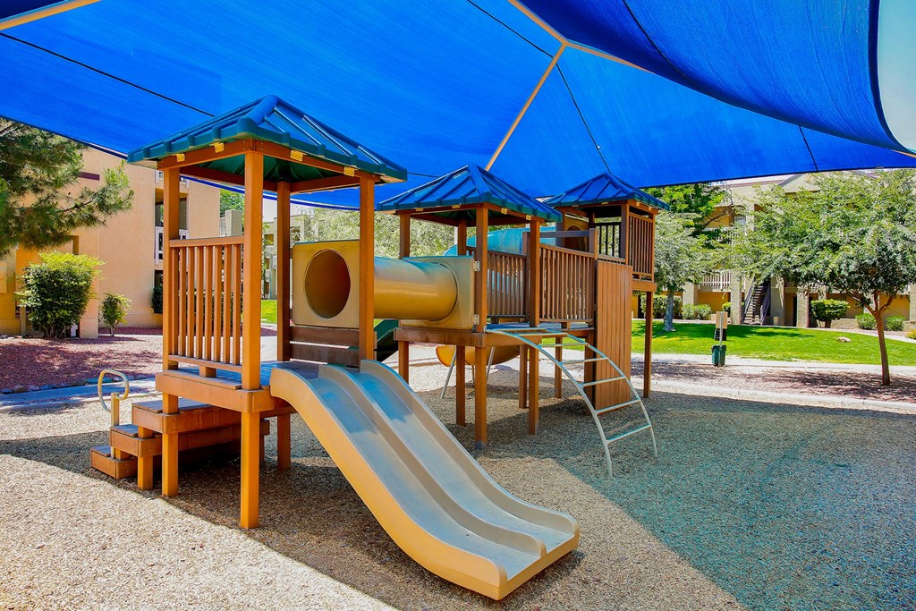 Childrens playground with a slide and playset at Pavilions at Pantano Apartments, Tucson, AZ, Arizona