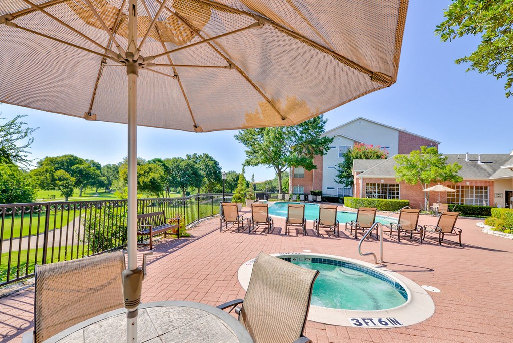 View of resort-style pool and jacuzzi with seating at Turnberry Isle Apartment Homes, Dallas, TX
