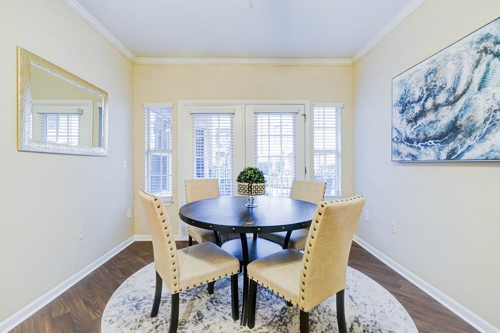Interior living room with dining room table and chairs at Villas at Katy Trail Apartments, Dallas