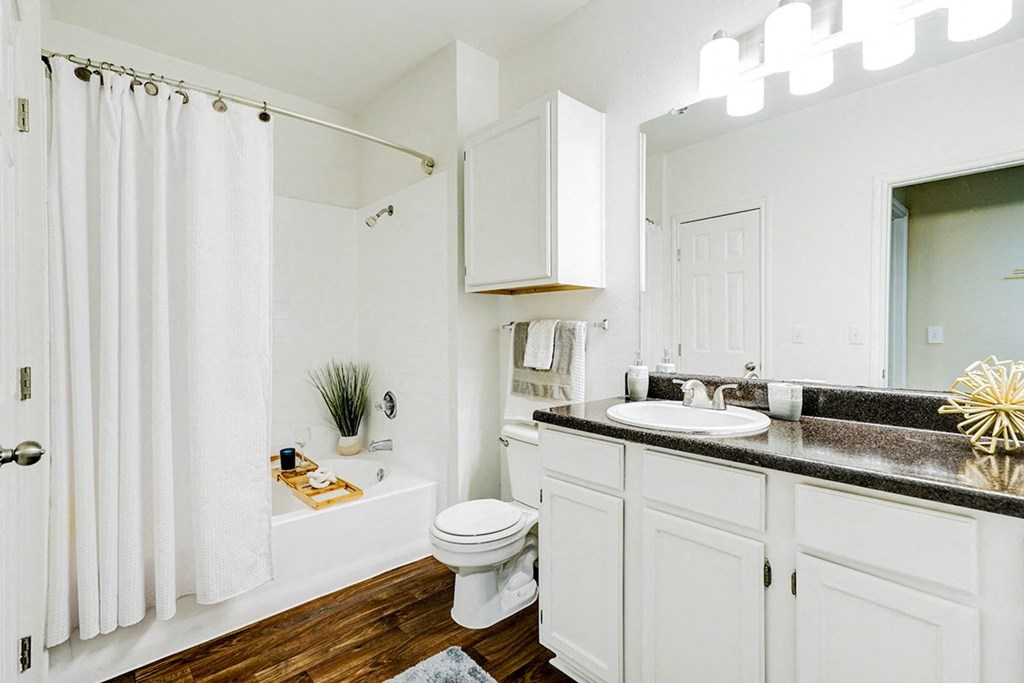 Bathroom with white fixtures and large vanity at Villas at Katy Trail Apartments, Dallas, 75201