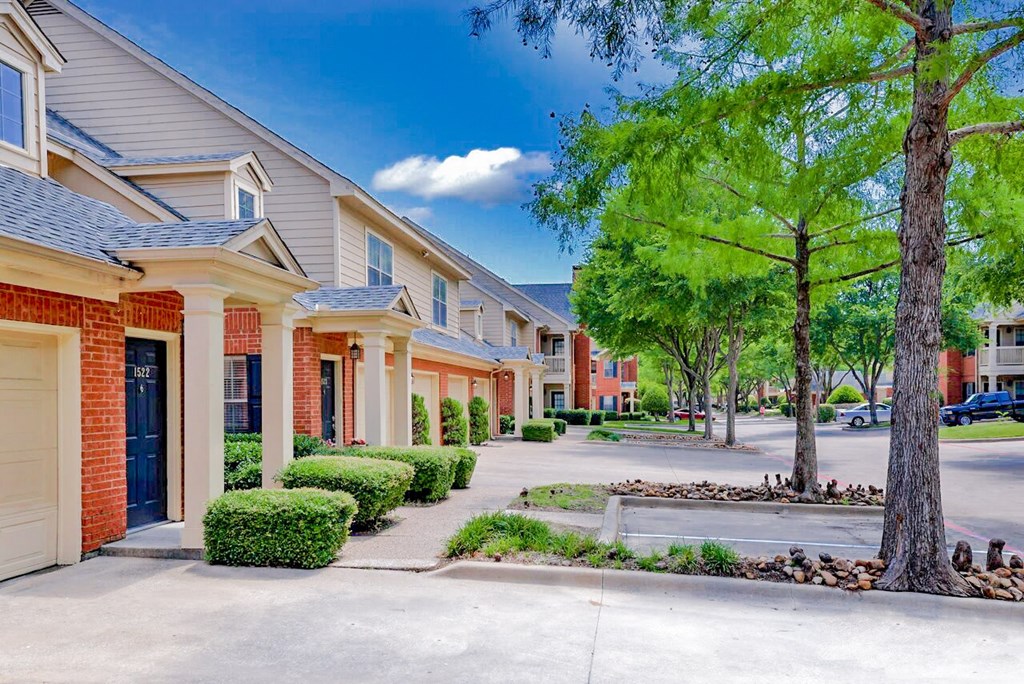 Exterior of apartments with trees at SaddleBrook Apartments, Dallas, Texas