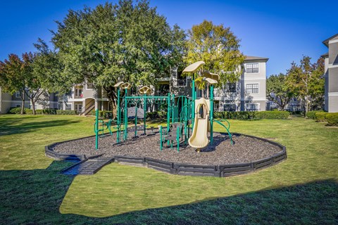 Green and yellow playground at Saxony at Chase Oaks, Plano