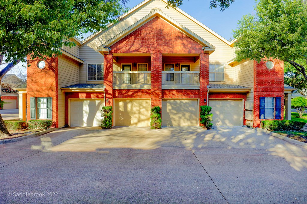 Exterior of apartment with parking garage at SaddleBrook Apartments, Dallas, TX, 75248