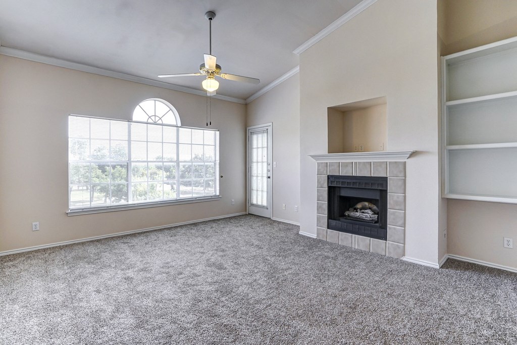 Bright and spacious living rooms with fireplaces at Turnberry Isle Apartment Homes, Dallas, Texas