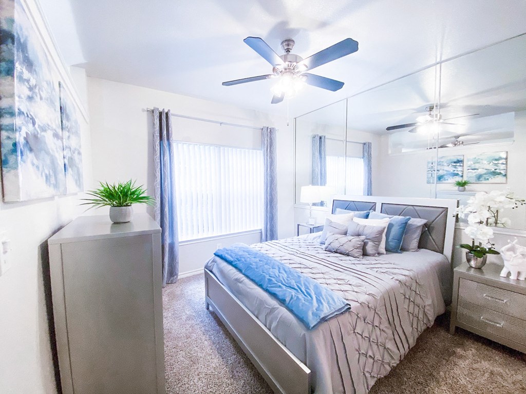 Well-lit bedroom with ceiling fan at Tuscany Square, Dallas