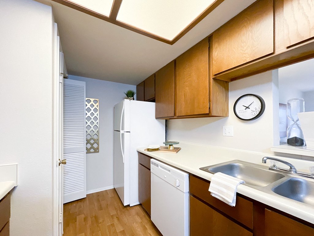 Interior kitchen view with wooden cabinets at Greenbriar Apartments, Tulsa, OK, 74136