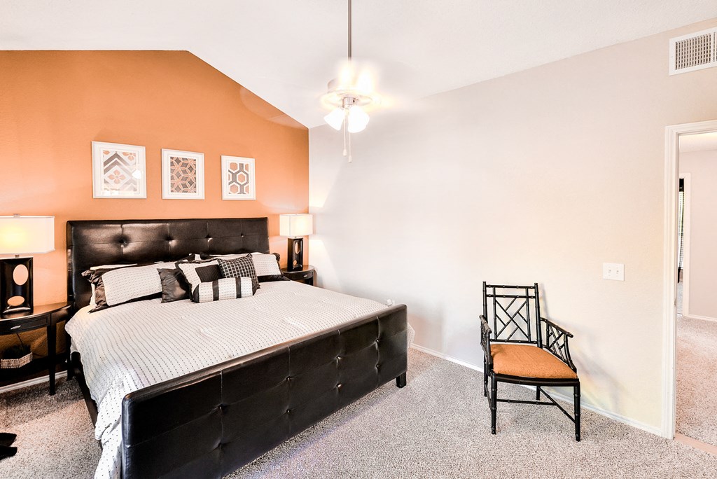 Spacious bedroom with orange accent wall at Winsted at Valley Ranch, Irving, 75063