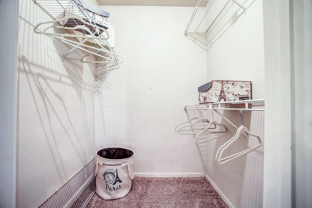 Interior walk-in style closet with white walls at Greenbriar Apartments, Tulsa, OK, 74136