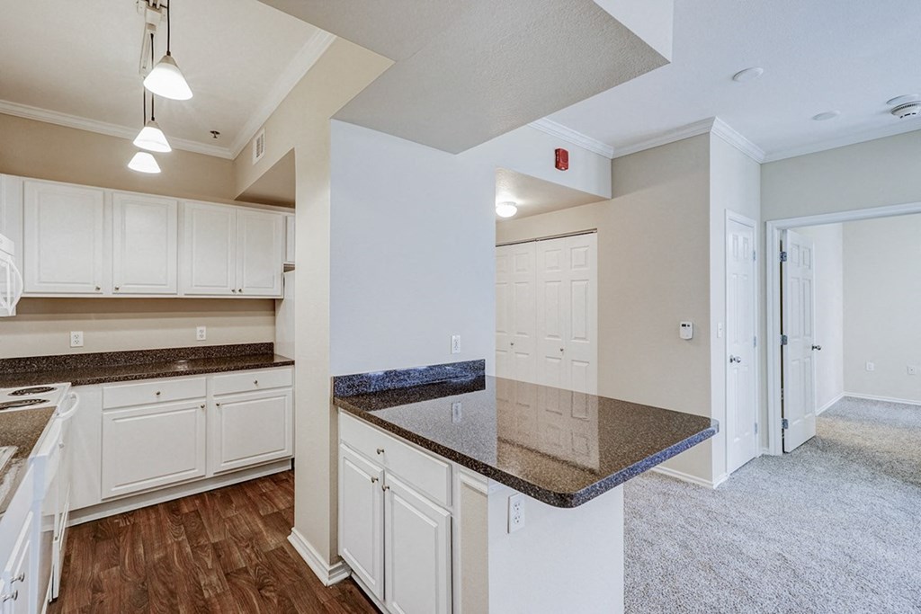 Open concept kitchen with living room and hallway view at Villas at Katy Trail Apartments, Texas, 75201