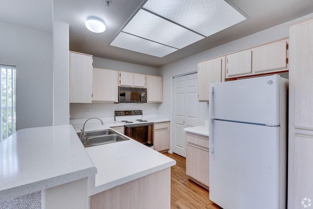 Kitchen with white appliances and countertop at Ventana, Scottsdale, 85260