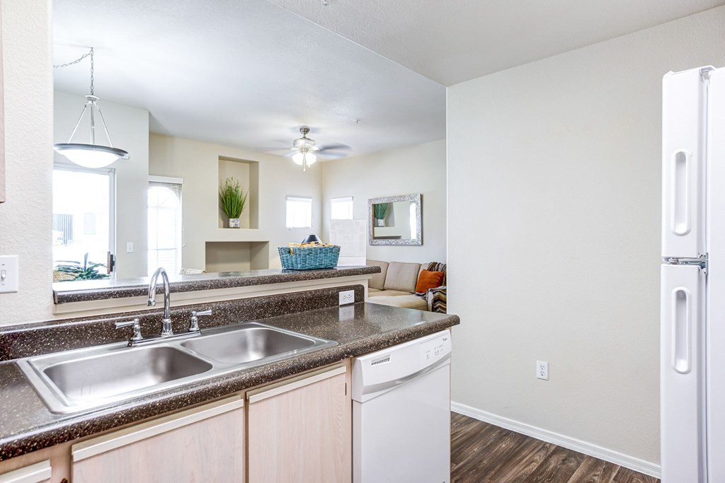 A kitchen with a white fridge and a stainless steel sink. at Ventana, Arizona, 85260