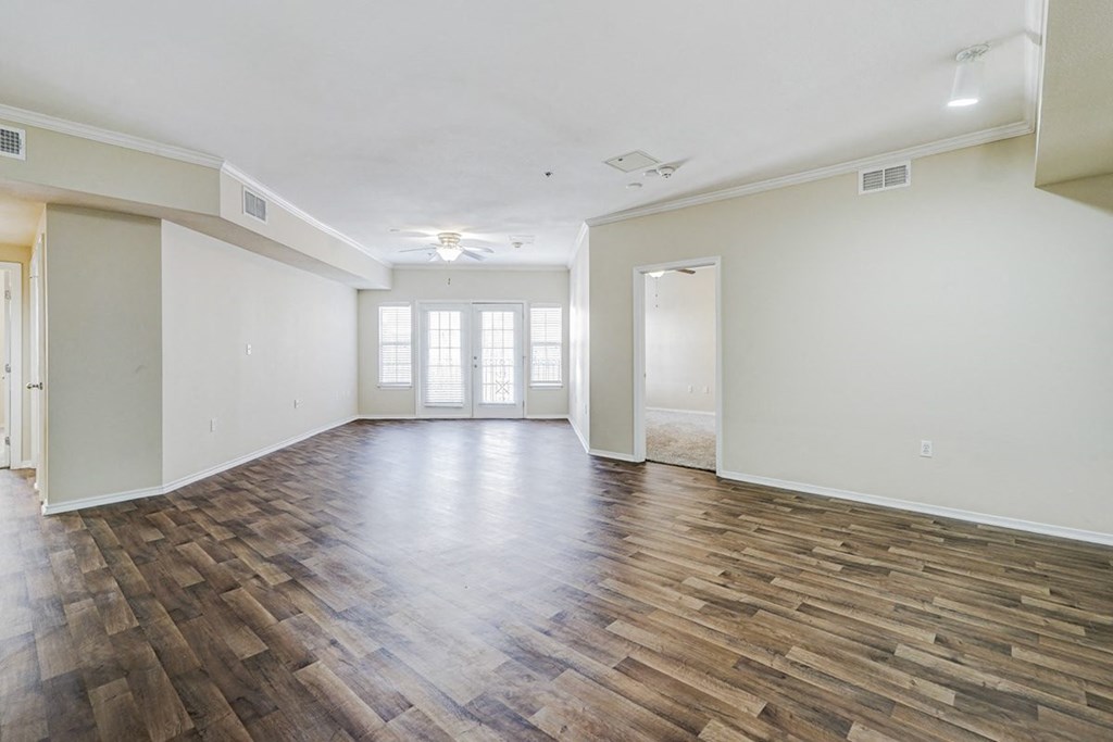 an empty living room with a hard wood floor and white walls at Villas at Katy Trail Apartments, Dallas, TX, 75201