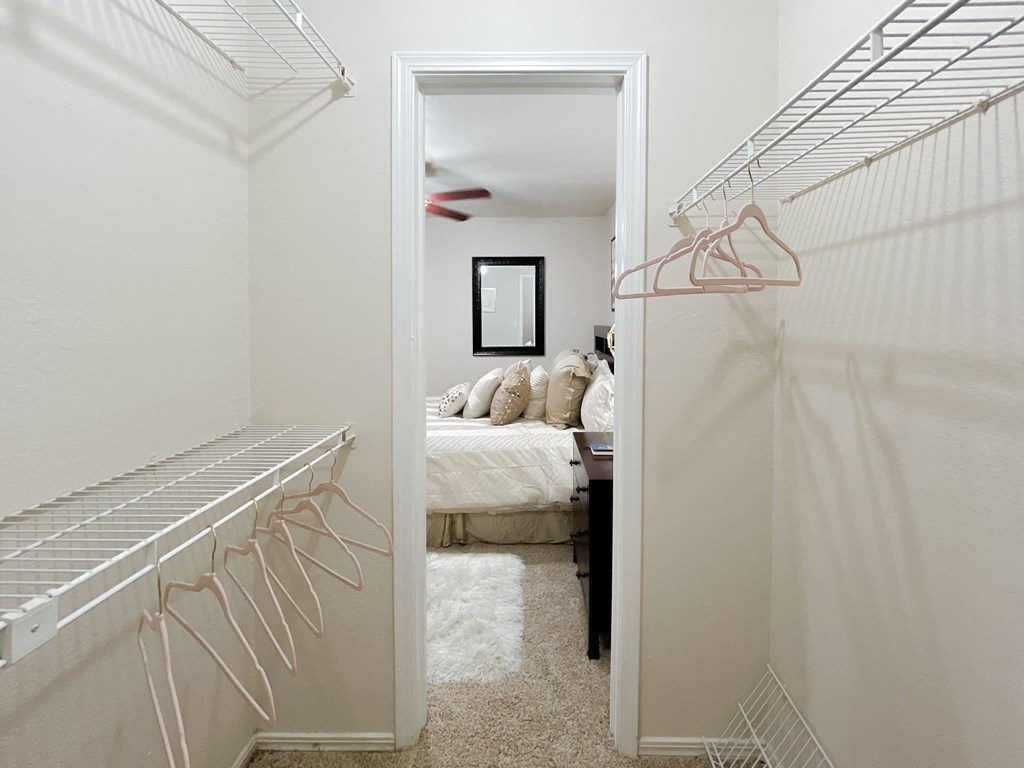 Walk-in style closet with beige carpeting at Greenbriar Apartments, Oklahoma, 74136