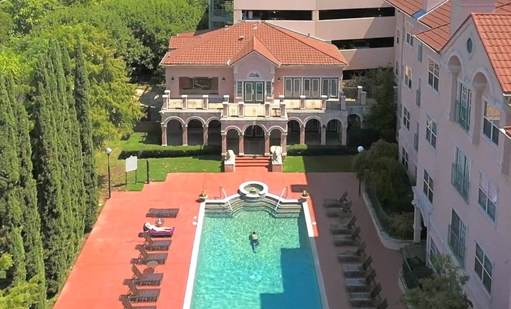 Aerial of resort-style pool with lounge chairs at Villas at Katy Trail Apartments, Texas