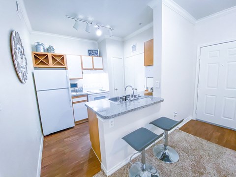 a kitchen with a island and a white refrigerator