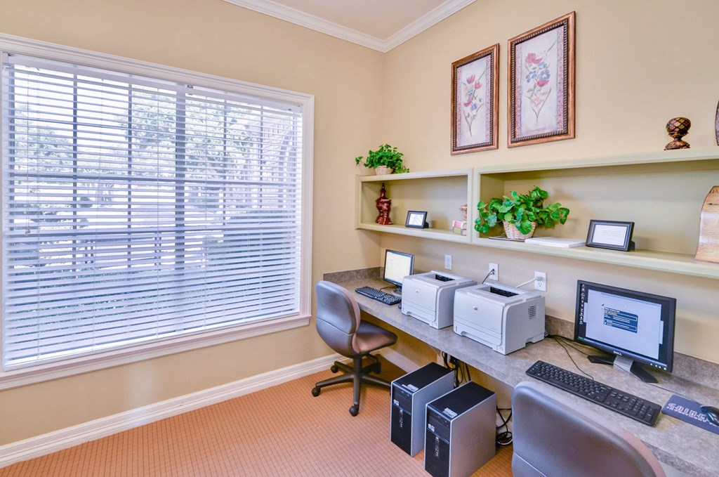 Community business center with computers and chairs at Turnberry Isle Apartment Homes, Dallas, Texas