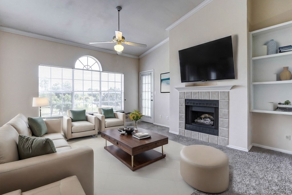 Light and bright living room with built in book shelves, large windows and fireplaces at Turnberry Isle Apartment Homes, Dallas, TX