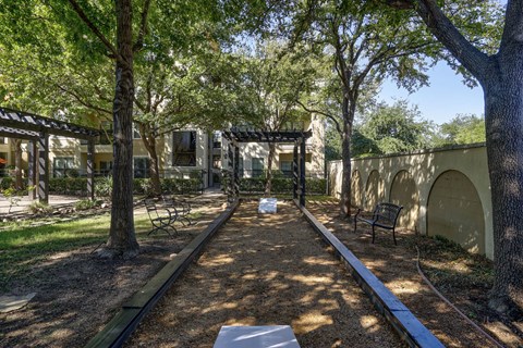 A park with a bench and a tree.