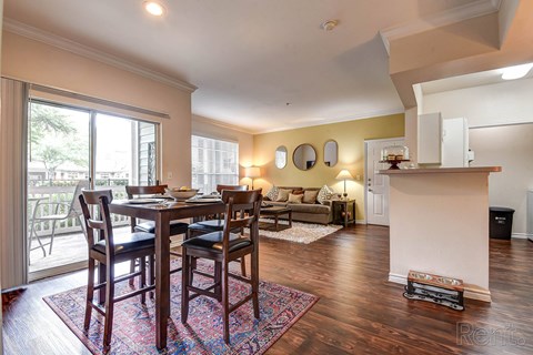 A dining room with a table and chairs.