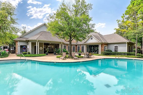 A large house with a pool in front.