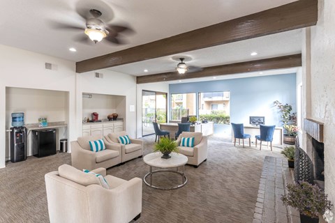 A living room with a white couch and a ceiling fan.