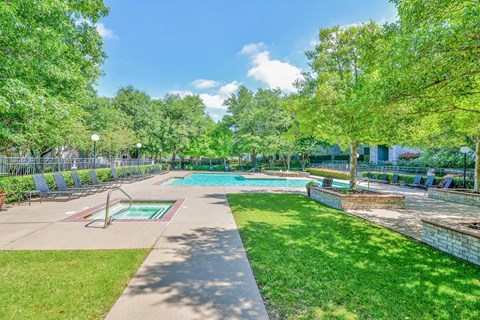 a park with a swimming pool and trees at Greysons Gate Apartments, Dallas, TX