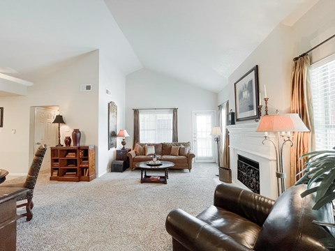 a living room with leather furniture and a fireplace