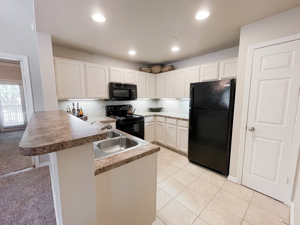 Spacious kitchen with tile flooring at SaddleBrook Apartments, Dallas, TX