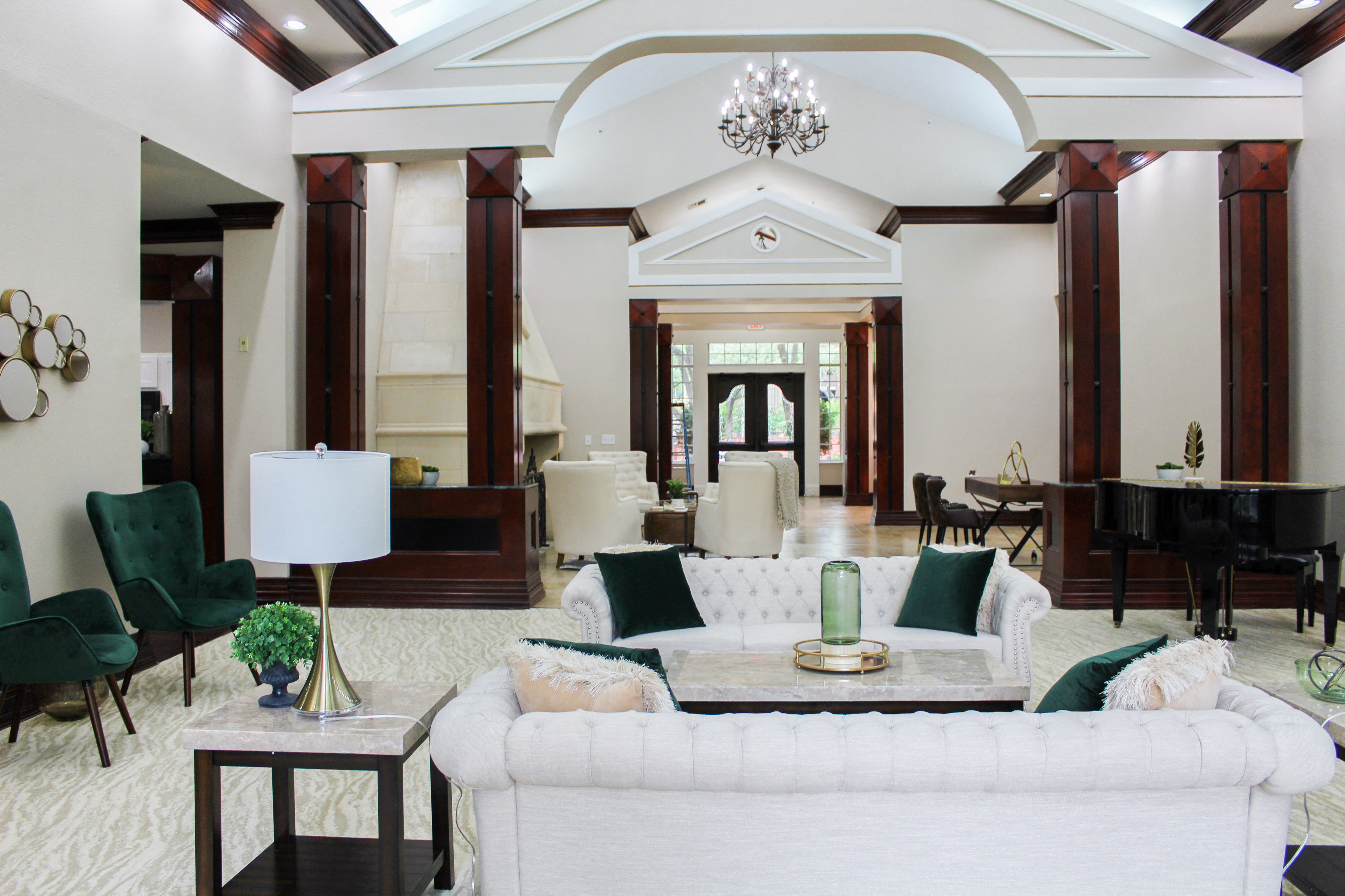 a large living room with a white couch and chairs