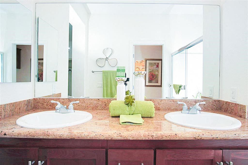 Bathroom with two sink and a mirror at Croix Townhomes, Henderson, Nevada