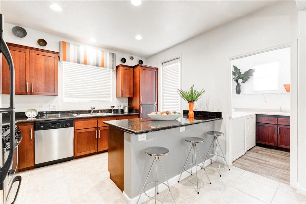 Stainless steel kitchen appliances and wood cabinets in kitchen at Croix Townhomes, Henderson, 89014