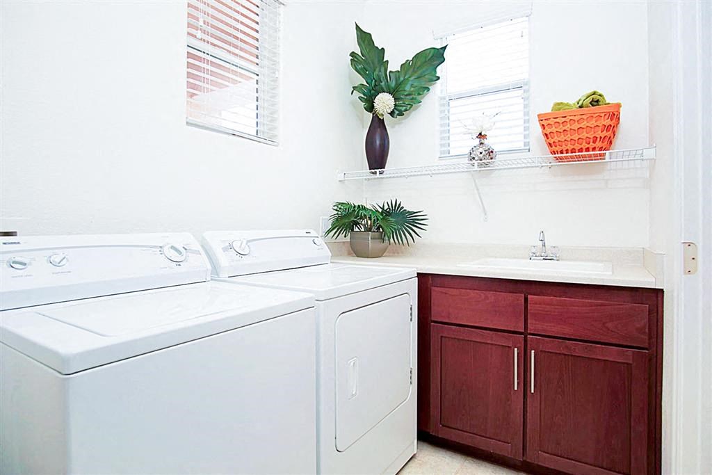 White washing machine and dryer in a laundry room at Croix Townhomes, Henderson, NV