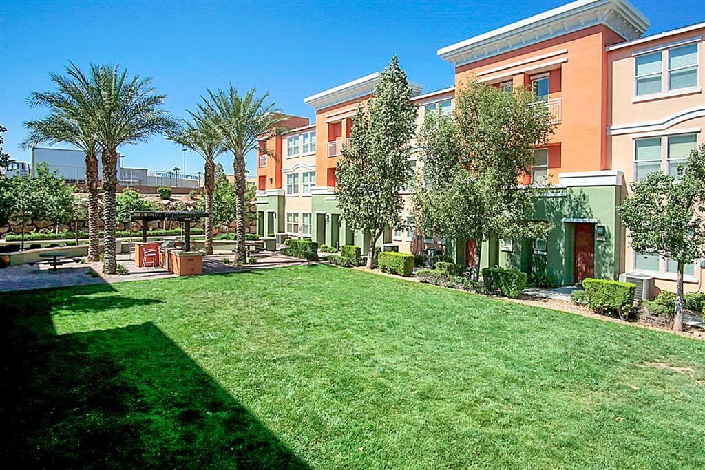 Large green lawn outside of apartment building at Croix Townhomes, Henderson, NV
