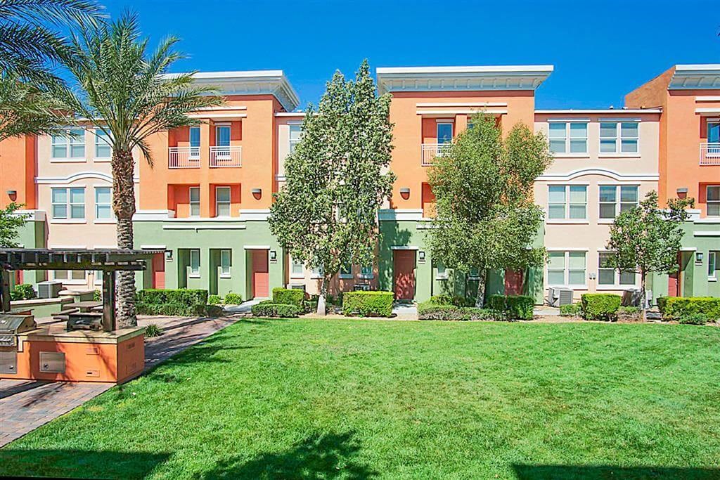 Exterior of apartment with green lawn beside it at Croix Townhomes, Henderson, NV, Nevada
