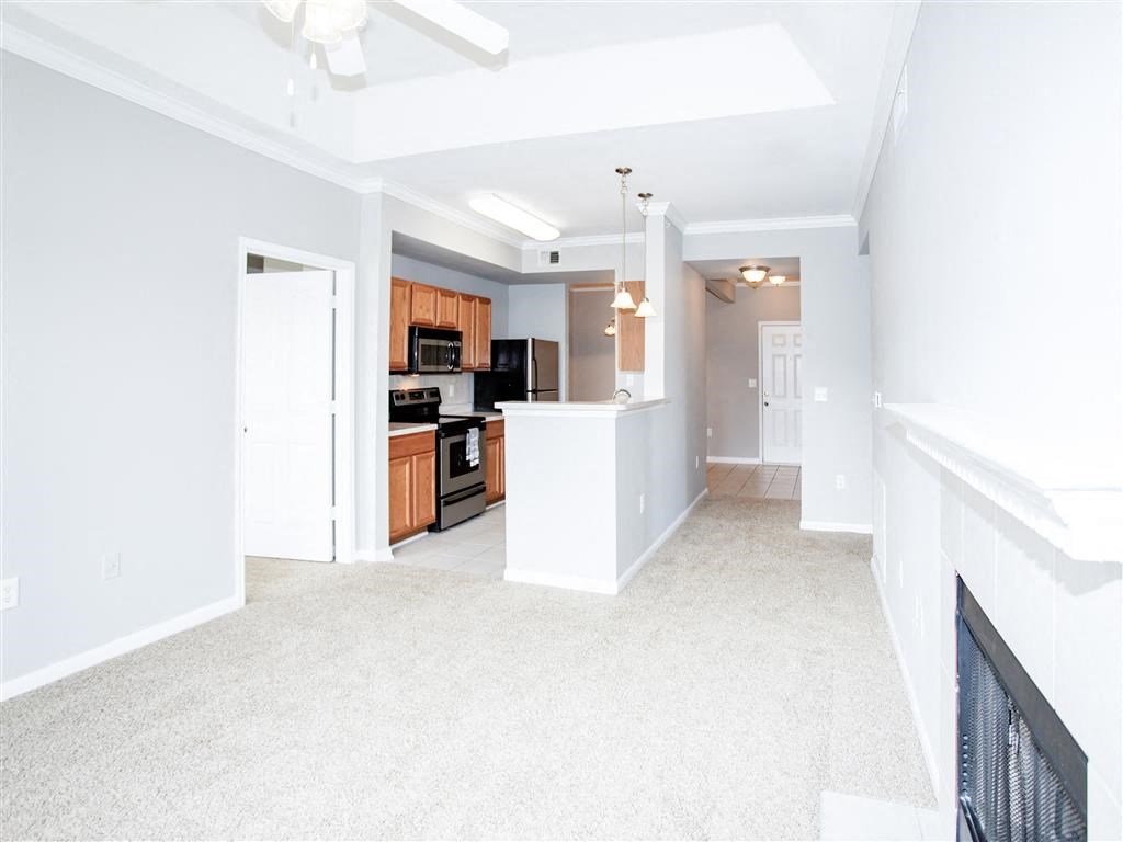 Pass-through kitchen and fireplace of Estancia Apartments For Rent Tulsa OK - 1, 2 , and 3 Bedroom Units Available