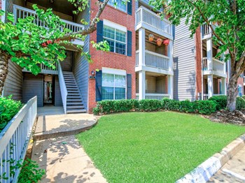 Lush, mature landscaping at Greenbriar in South Tulsa, OK. Quiet and secluded apartments for rent. Available now. - Photo Gallery 2